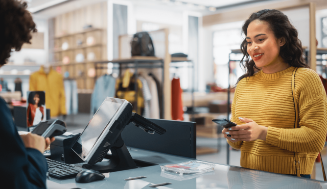 Woman paying at clothing store