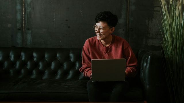 Person sitting on a couch on a laptop