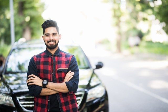 Young man by car