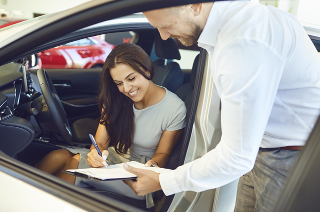 Woman Signing for Car