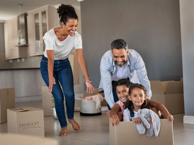 Family having fun in new house