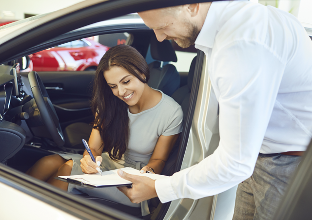 Woman Signing for Car